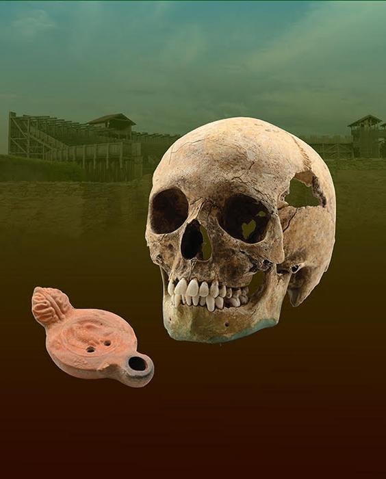 На этом изображении изображен череп восточноафриканца плюс масляная лампа с орлом легионера, с которой он был похоронен.