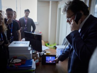 С.П. Кулик демонстрирует журналистам квантовый телефон. Фото: Елена Либрик / «Научная Россия»